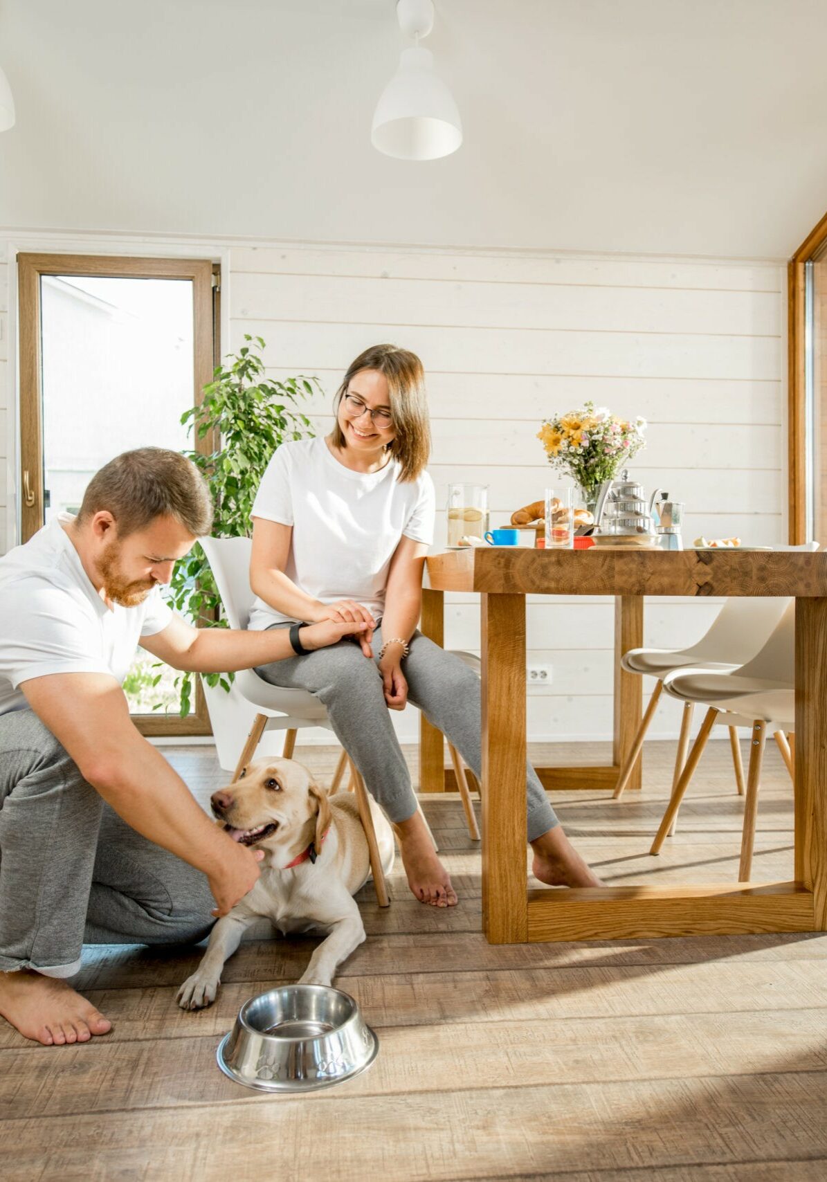Happy couple with dog at home | Contractors Carpet & Flooring