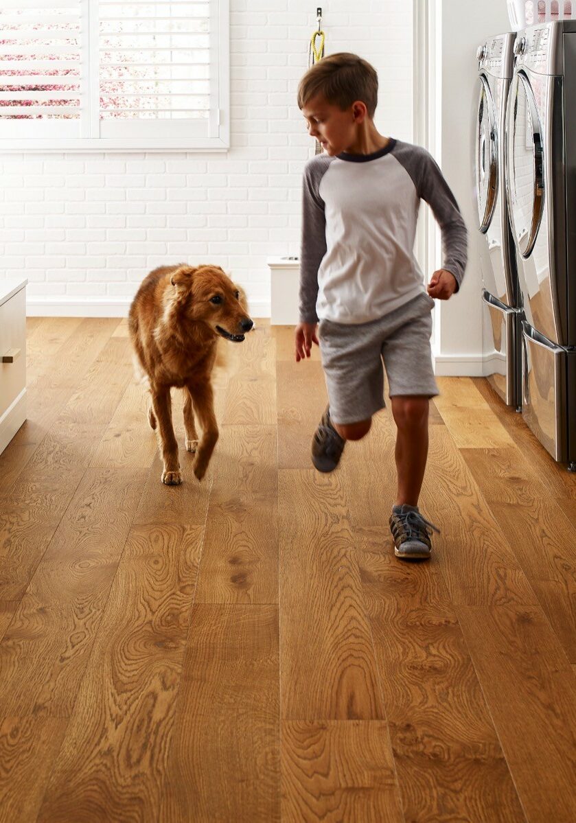 Kid running with dog | Contractors Carpet & Flooring